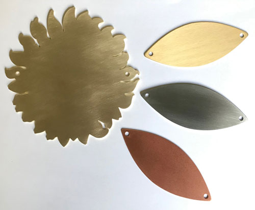 sunflower and leaf plaques in gold, silver & bronze. 
