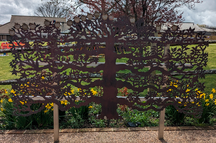 copper espalier fruit tree with brass apple plaques